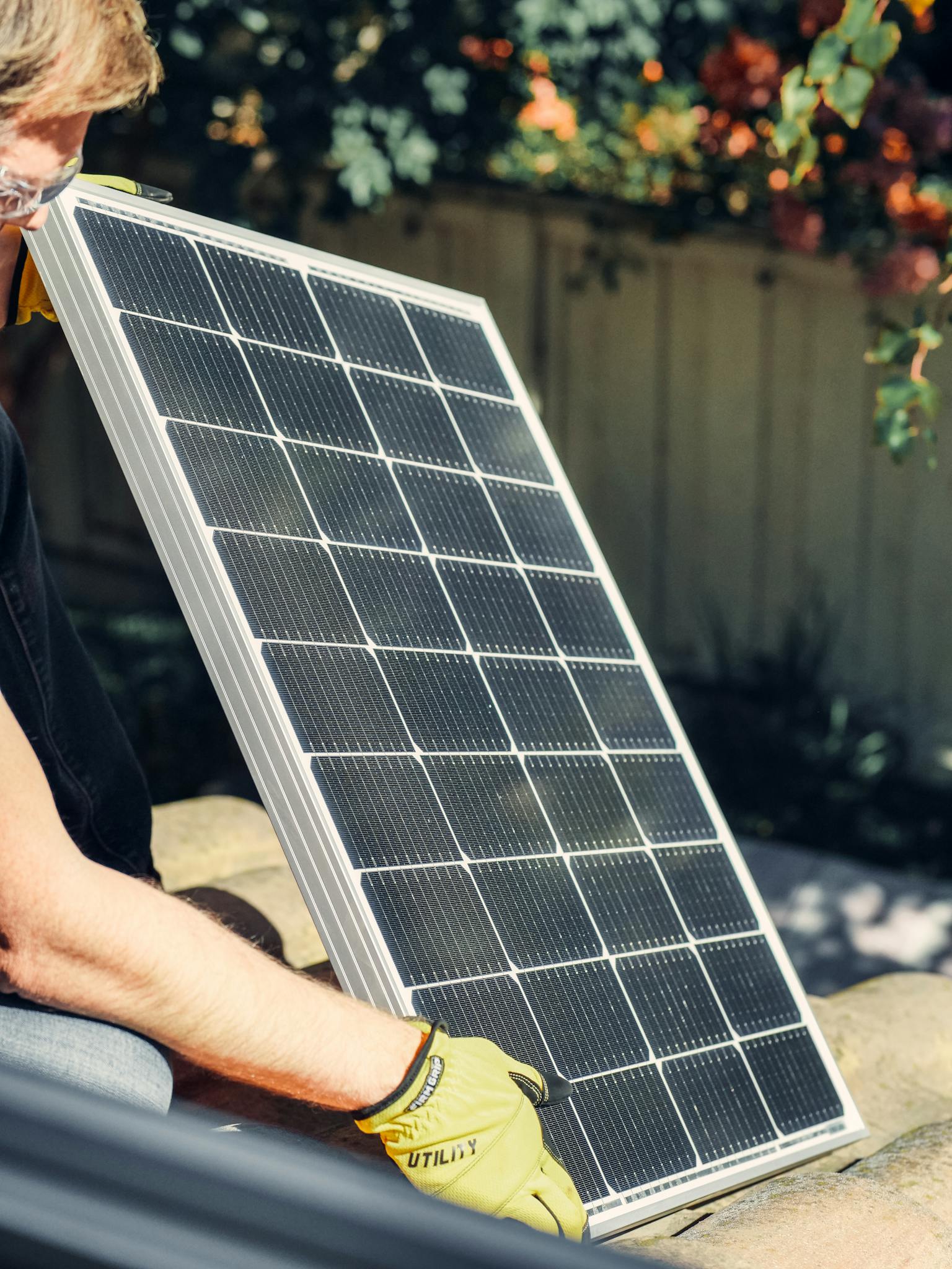Home A Worker Installs A Solar Panel In A Garden Promoting Clean Energy. 9875410 1536x2048