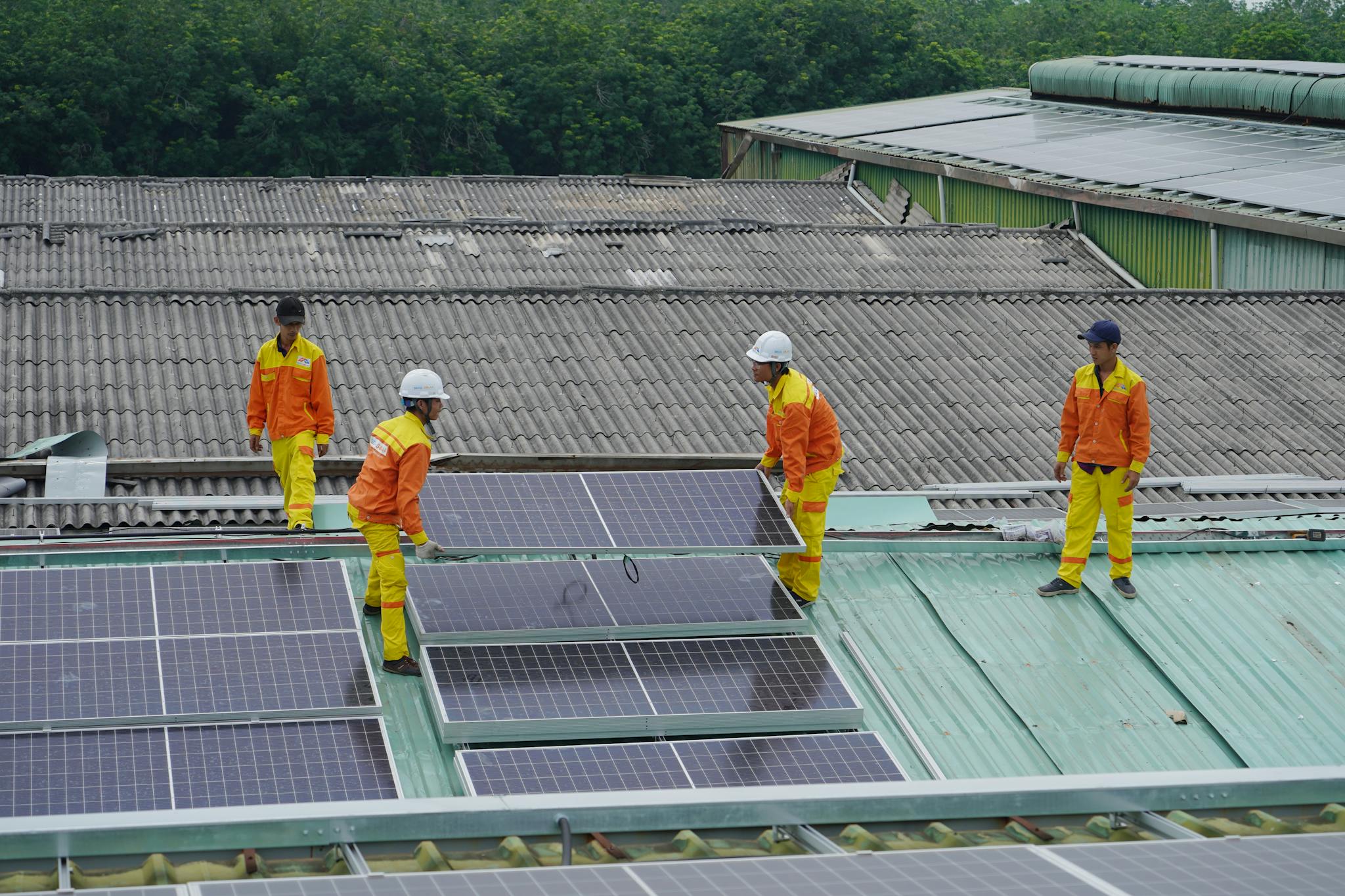 Home Workers Installing Solar Panels On A Roof For Sustainable Energy Solutions. 11645008 2048x1365